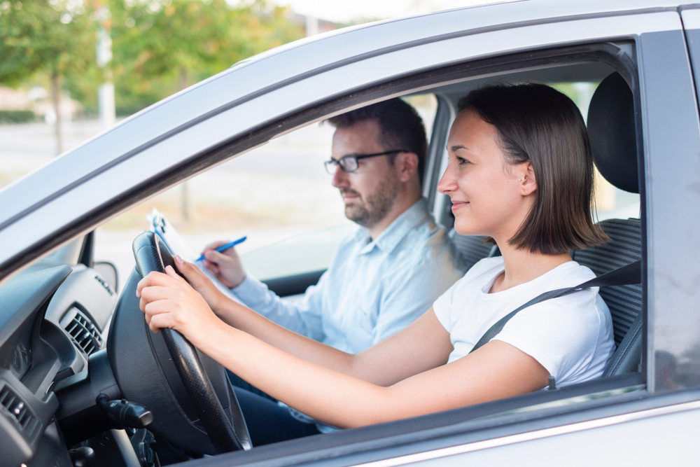 Father teaching teen girl how to drive