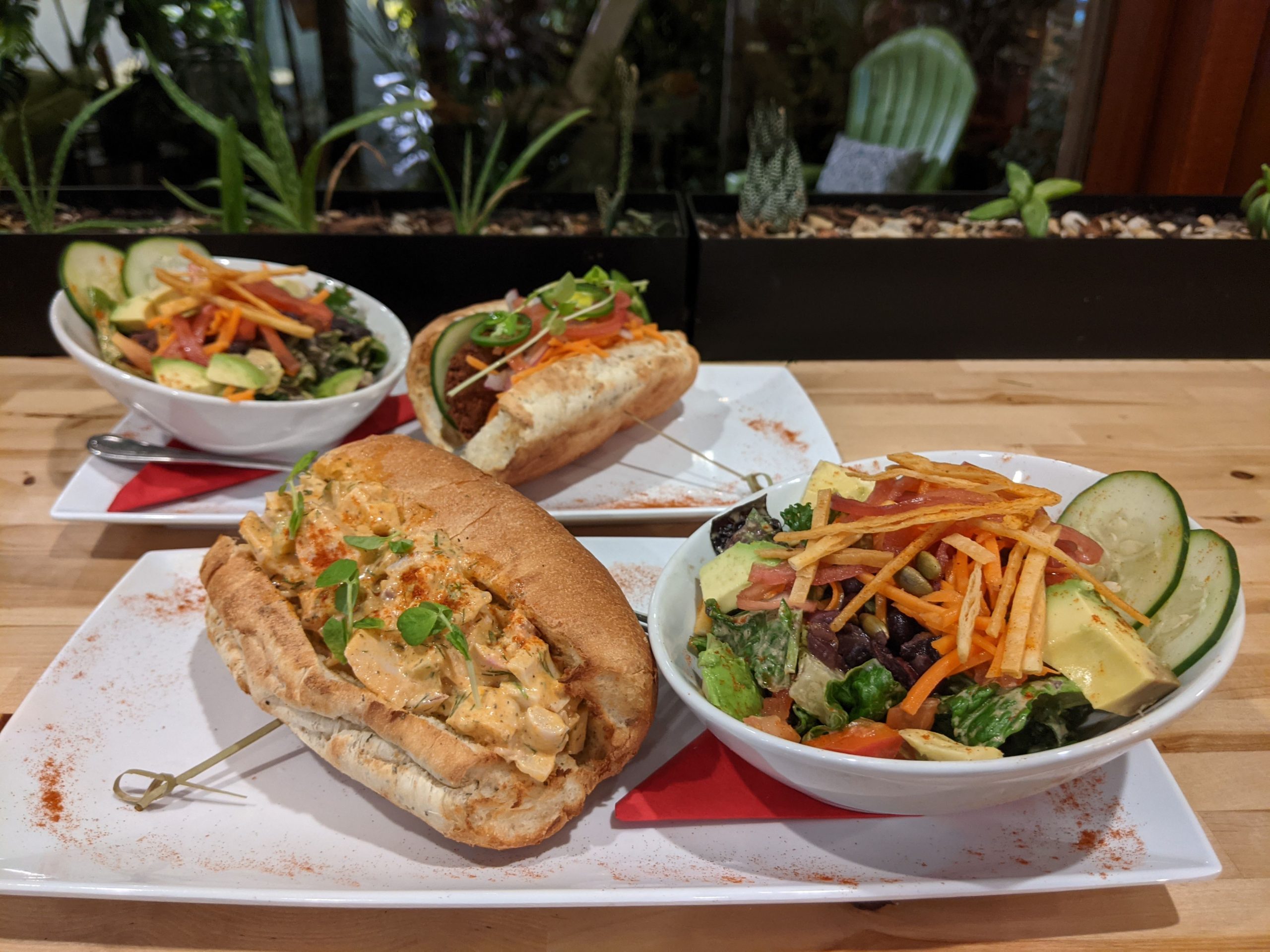 Lobster roll and bánh mì with a view of the outdoor patio at Green Cup Café