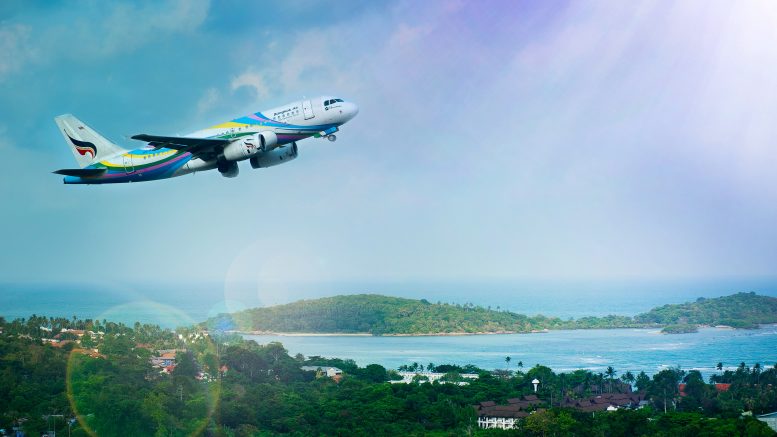 airplane seen from sky flying over city