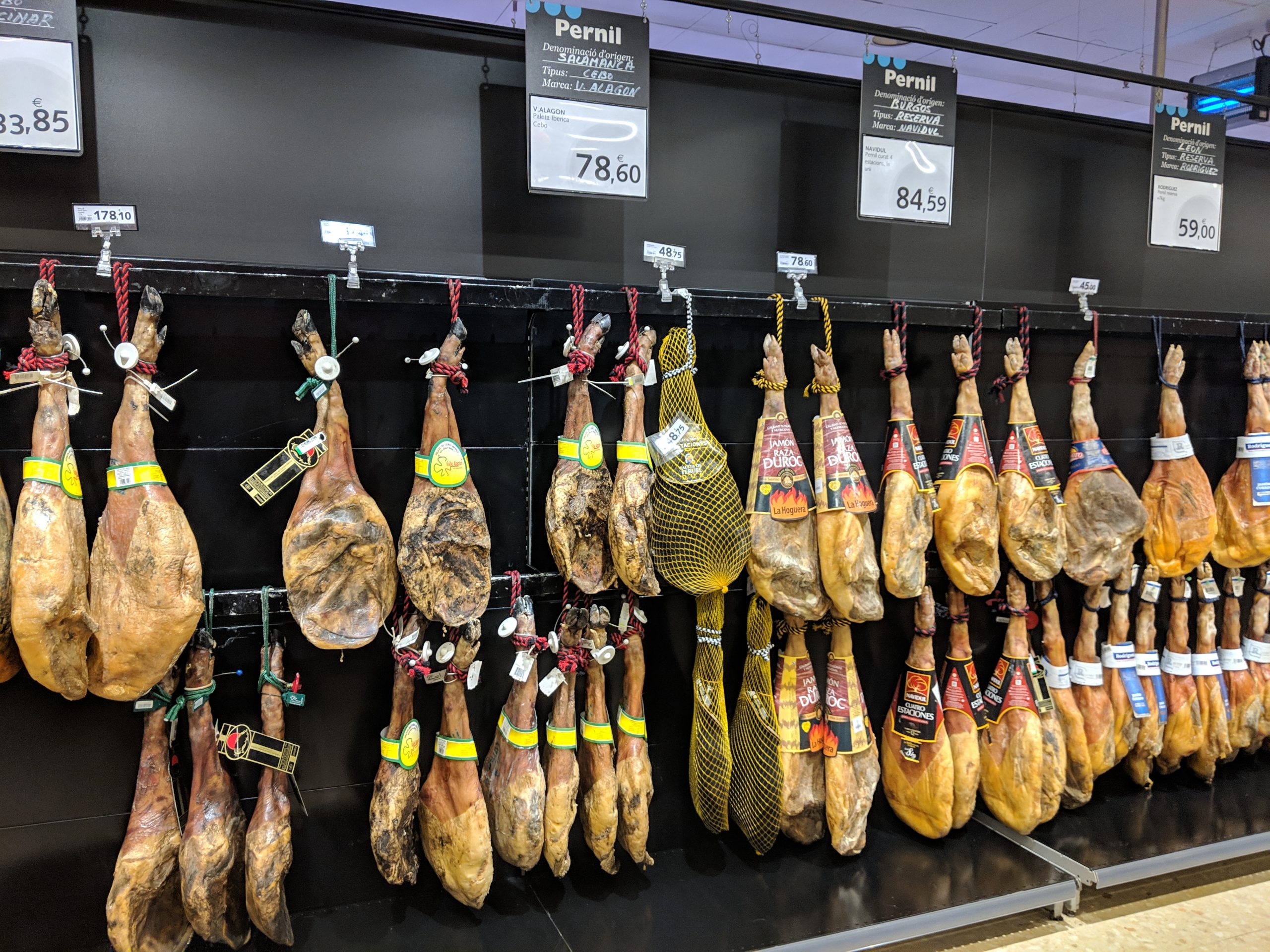 cured meat hanging in a store in Barcelona