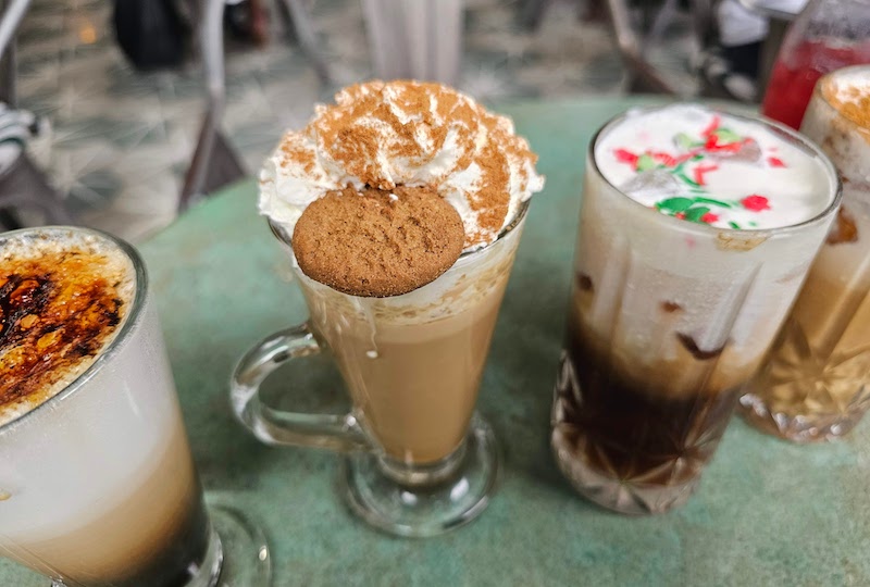 Cre?me bru?le?e cappuccino on the left, gingerbread latte in the center, and the peppermint matcha and churro latte to the right at Java _ Jam